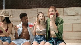 Group of diverse friends enjoying slices of watermelon, laughing and talking together by swimming pool - Powered by Shutterstock - Get 15% off with code: PIKWIZARD15