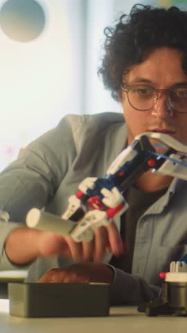 Interactive and Creative STEM Education in Primary School: Talented Boy Studying Robotic Arm Model with Teacher. Young School Student During Science and Technology Lesson in Classroom. Vertical Shot.