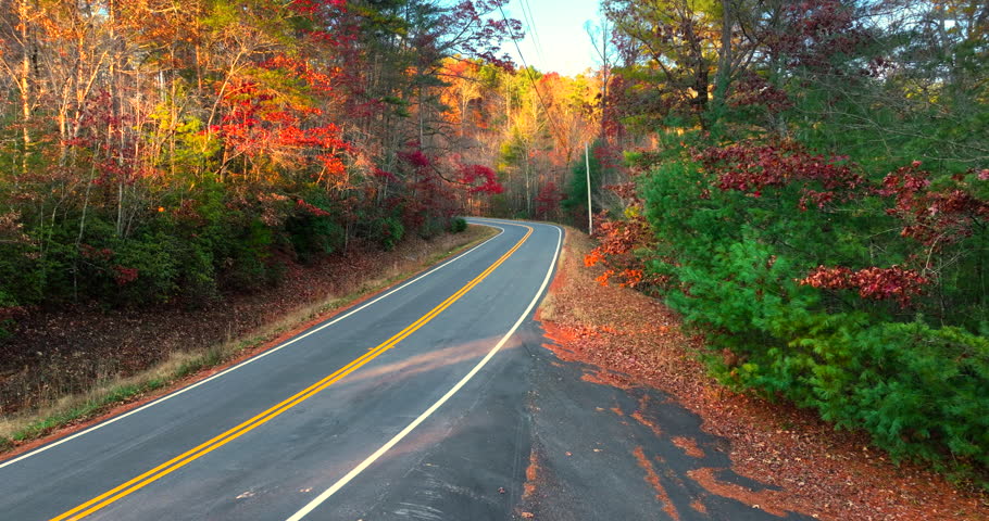 Blue Ridge Parkway in full autumn splendor. North Carolina mountain highway lined with brilliant red, orange, and gold foliage