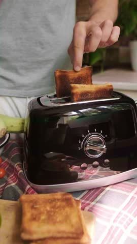 Man prepares toast with vegetables and avocado using a toaster quick and healthy morning breakfast routine at home