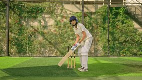 Indian gen z athlete sports woman standing outdoor match play ground wear white uniform and protective helmet. Asian teen age female cricket player hold bat do practice hitting ball at playground  - Powered by Shutterstock - Get 15% off with code: PIKWIZARD15