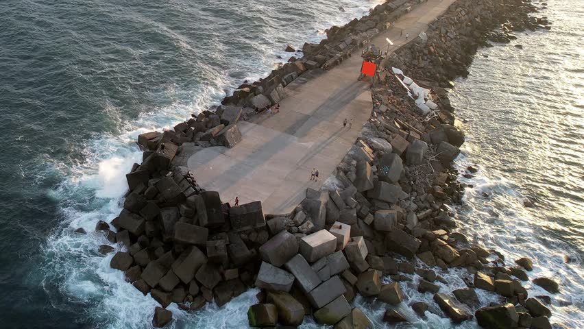 Newcastle, New South Wales, Australia, Breakwater stretching into the deep blue sea under a clear sky. The serene scene showcasing the harmony of ocean waves and sky hues