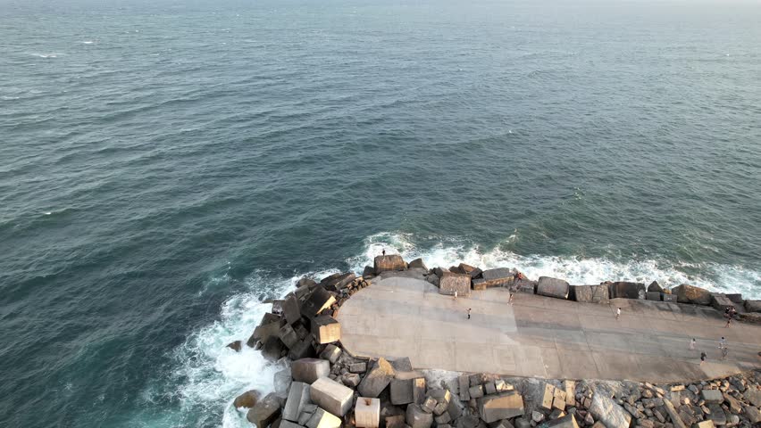Newcastle, New South Wales, Australia, Breakwater stretching into the deep blue sea under a clear sky. The serene scene showcasing the harmony of ocean waves and sky hues