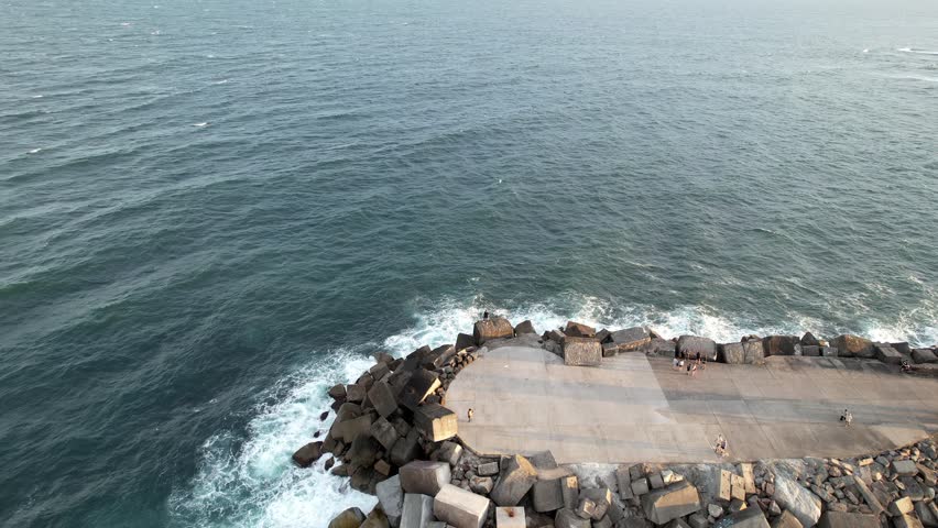 Newcastle, New South Wales, Australia, Breakwater stretching into the deep blue sea under a clear sky. The serene scene showcasing the harmony of ocean waves and sky hues