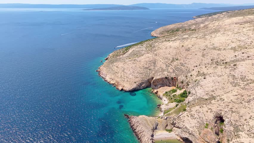 Remote cove with boats and beach Mali Pečen near Stara Baška on Krk island, Croatia