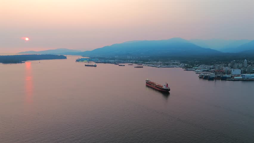 Aerial view of cargo bulkers near the port of North Vancouver at sunset.