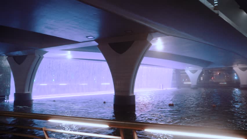 night view of dubai in the united arab emirates. Downtown, waterfall, river, gulf, skyscrapers of the business center in the evening. Islamic culture and travel