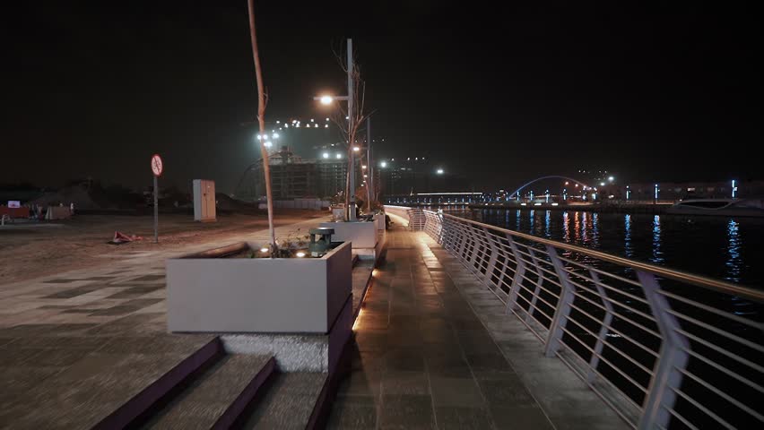 night view of dubai in the united arab emirates. Downtown, waterfall, river, gulf, skyscrapers of the business center in the evening. Islamic culture and travel