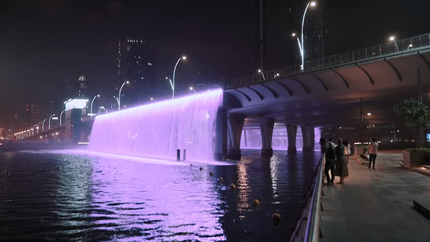 night view of dubai in the united arab emirates. Downtown, waterfall, river, gulf, skyscrapers of the business center in the evening. Islamic culture and travel