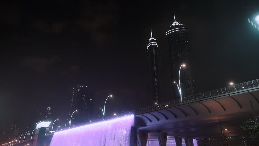 night view of dubai in the united arab emirates. Downtown, waterfall, river, gulf, skyscrapers of the business center in the evening. Islamic culture and travel