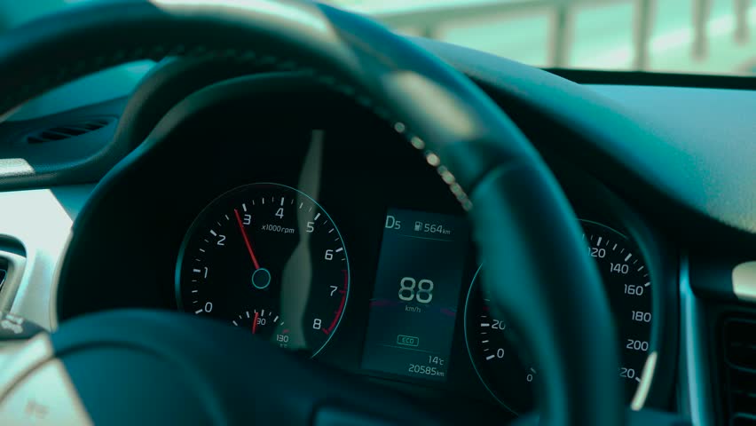 Car speedometer in ECO mode for reduced emissions showing rising speed and current gear. Dashboard indicating fuel range, engine RPM, and temperature. Digital display presenting driving data with