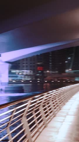 night view of dubai in the united arab emirates. Downtown, waterfall, river, gulf, skyscrapers of the business center in the evening. Islamic culture and travel