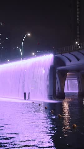night view of dubai in the united arab emirates. Downtown, waterfall, river, gulf, skyscrapers of the business center in the evening. Islamic culture and travel