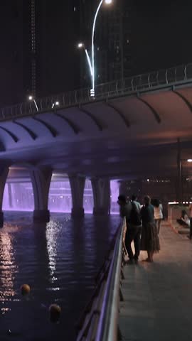 night view of dubai in the united arab emirates. Downtown, waterfall, river, gulf, skyscrapers of the business center in the evening. Islamic culture and travel