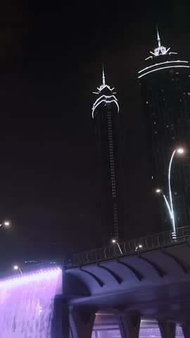 night view of dubai in the united arab emirates. Downtown, waterfall, river, gulf, skyscrapers of the business center in the evening. Islamic culture and travel