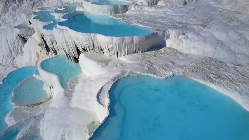 Pamukkale Turkish, Natural travertine pools terraces with blue water, aerial top view.