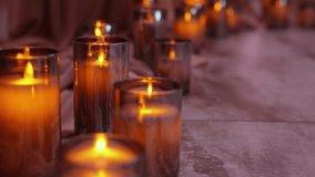 Burning white candles in a glass bulb stand decorate the restaurant hall at the wedding - Powered by Shutterstock - Get 15% off with code: PIKWIZARD15