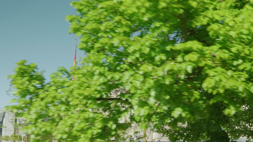 Historical reichstag Building With German Flag in a Sunny Green Landscape