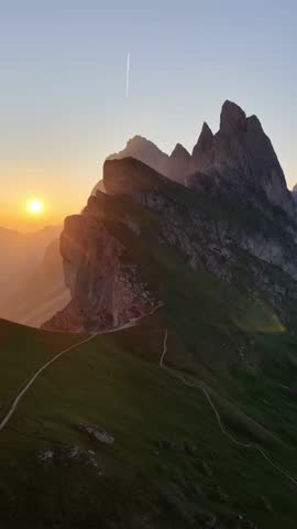 vertical video of sunrise in the Dolomites in Italy, hiking in Italian Alps, travel in Italian Dolomites, drone shot of Seceda mountain peak in Puez Odle natural park in the Dolomites. 