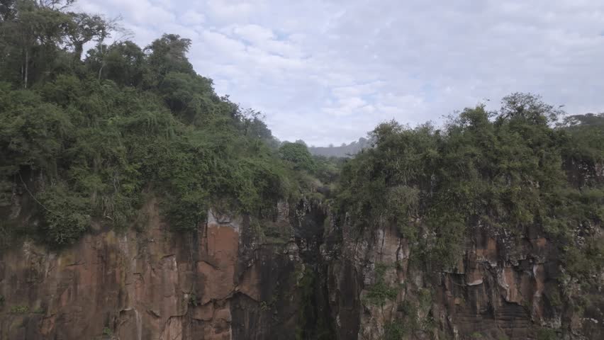 Drone aerial view of the Iguazu Falls, on the border between Argentina and Brazil. Located in the Iguazu National Park, it is considered one of the seven wonders of the world