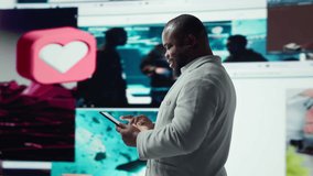 Smiling person using tablet, enjoying leisure time with online video content. Joyful man browsing social media app on device in front of digital backdrop filled with clips collage layout, camera A - Powered by Shutterstock - Get 15% off with code: PIKWIZARD15