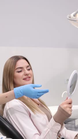 Patient smiling contentedly during dental checkup at modern clinic facility. Vertical video
