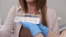 Dental professional evaluating shade for veneers. Precision in color selection is vital for aesthetics - Powered by Shutterstock - Get 15% off with code: PIKWIZARD15