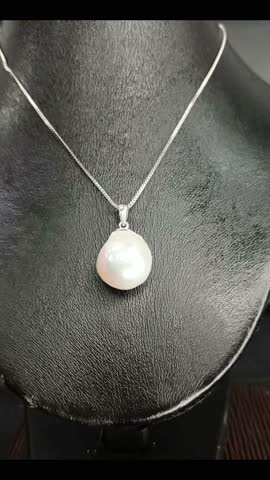 Elegant Pearl Pendant on Silver Chain Displayed on Dark Background