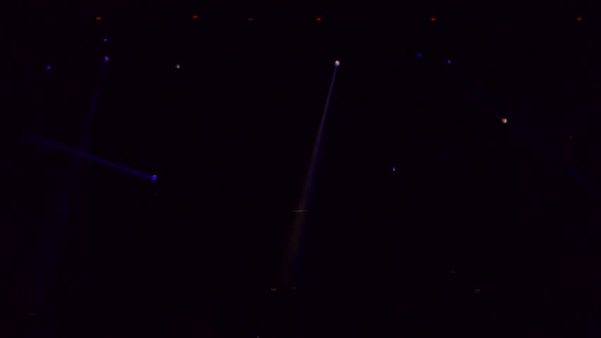 Colorful stage lights. Gold spotlights and white laser holograms spins, turns and emits light bright beams. Lighting equipment and light effects for design, concert hall and stage lighting during show