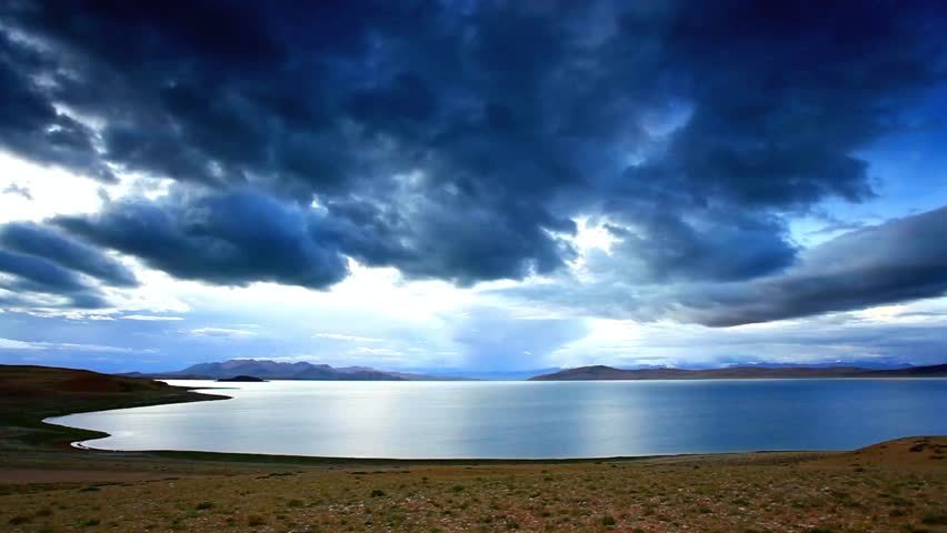 Lake and mountains under a cloudy sky landscape