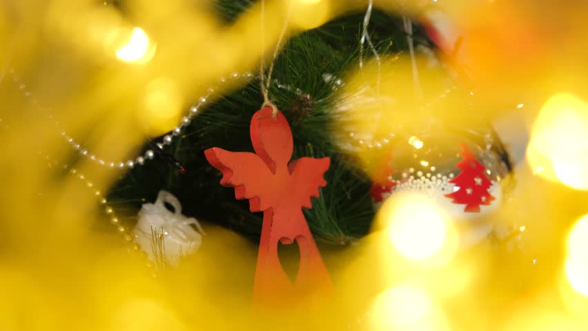 Christmas Tree and Ornament Angel. Golden Blurred Holiday Lights with Festive Glow