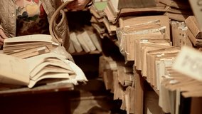 person reading old archival records in vintage library archive room. Historical document research. vintage archival books on library shelf.Historical recordkeeping, retro documents, data preservation - Powered by Shutterstock - Get 15% off with code: PIKWIZARD15