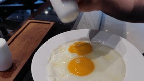 Breakfast with a plate of half-boiled egg with yolk. Hotel guests add salt and pepper seasoning to give it flavor.
Simple breakfast. - Powered by Shutterstock - Get 15% off with code: PIKWIZARD15