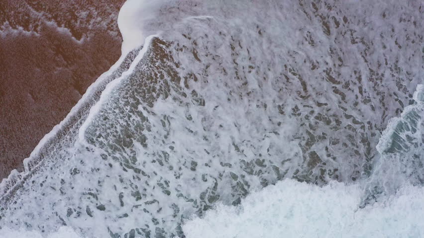 Atlantic ocean waves washing sandy coast at Farol da Nazaré in Nazare, 4K aerial beautyful natural background video
