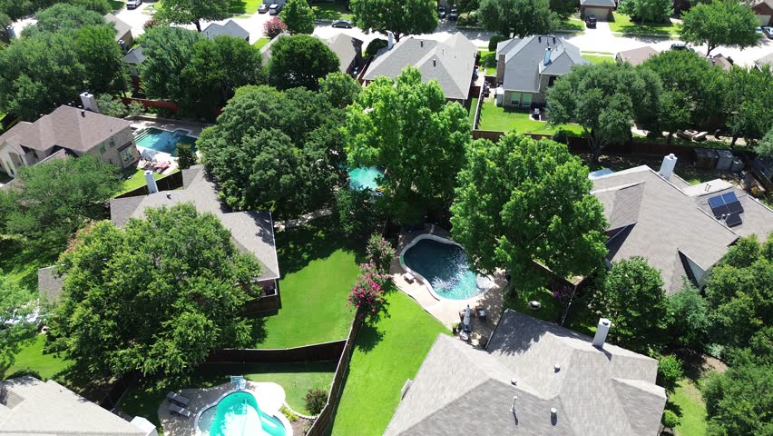 Lush green homes mature trees, rooftop solar panel arrays, angled installations for optimal sunlight capture, supporting clean efficiency energy, lower bills, sustainable, DFW metroplex, Texas. USA