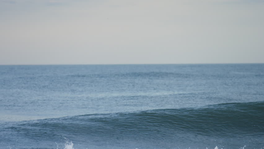 Man surfing on a big wave in an ocean, Long Beach Island, New Jersey, US.