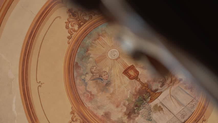 religious ceiling painting with chalice angels wheat and grapes in church