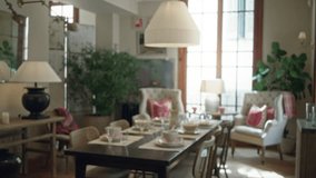 Cozy living room with blurred elegant dining setup and plush chairs creating a warm home atmosphere, featuring soft lighting and neutral, inviting decor. - Powered by Shutterstock - Get 15% off with code: PIKWIZARD15