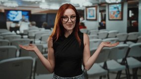 Woman smiling in an art gallery setting, glasses, casual outfit, redhead, beautiful, adult, person, attractive, caucasian, indoor environment depicted. - Powered by Shutterstock - Get 15% off with code: PIKWIZARD15