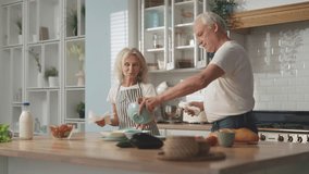 Do housework together, elderly spouses wiping dishes after washing and chatting. Happy married couple in old age, calm and joyful aged people spending weekend at home, wash kitchenware, serving table - Powered by Shutterstock - Get 15% off with code: PIKWIZARD15