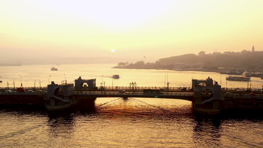 Scenic view of the Galata Bridge over the Golden Horn during sunset in Istanbul, Turkey.