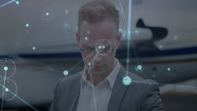 Business executive checking watch beside private jet engaging hologram interface for tracking data. Technology, innovation, luxury, sophistication, networking, futuristic, corporate - Powered by Shutterstock - Get 15% off with code: PIKWIZARD15