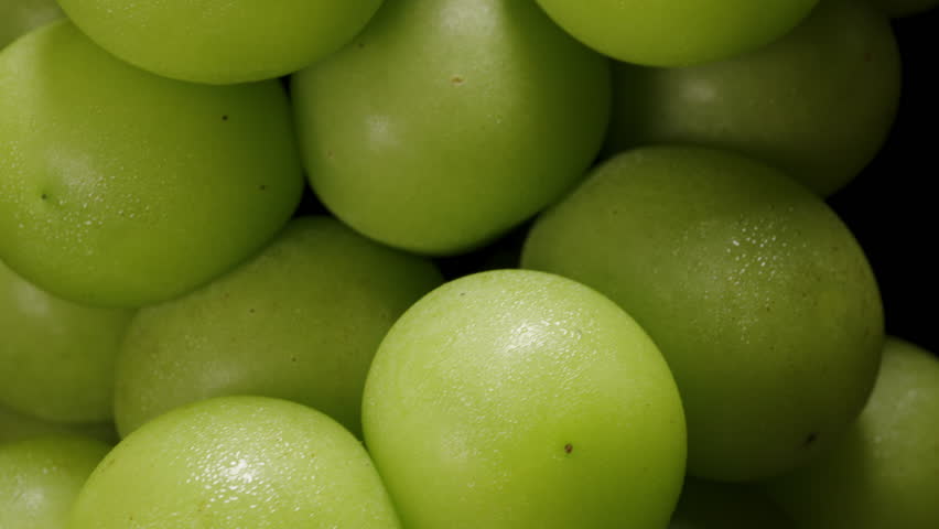 Ultra Close-Up of Japanese Green Grapes Rotating as Camera Slowly Moves Upward with Emphasis on Skin Texture and Natural Imperfections, Organic Fruit Concept.