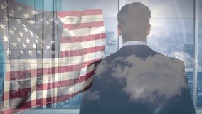 Businessman standing at window causing American flag animation with clouds evoking business drive. Corporate, patriotism, skyscraper, reflection, modern, ambition, leadership - Powered by Shutterstock - Get 15% off with code: PIKWIZARD15