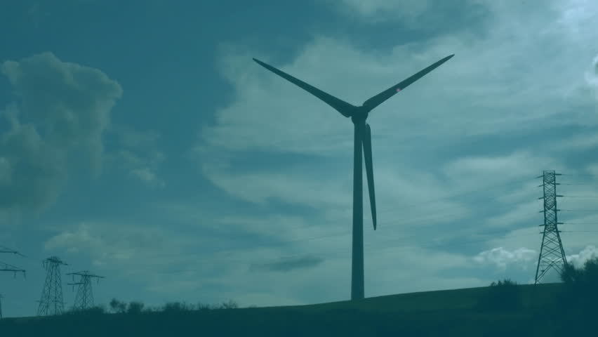 Over grid overlay, wind turbine with power towers charting red and blue lines marking energy output. Renewable, sustainability, data visualization, infrastructure, blueprints, technology, environment - Powered by Shutterstock - Get 15% off with code: PIKWIZARD15