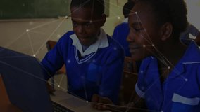 Network overlay appearing in classroom as girl guiding boy typing on laptop boosting education. Educational, digital, collaboration, youth, technology, classroom, innovation - Powered by Shutterstock - Get 15% off with code: PIKWIZARD15