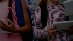 Students looking at tablets activating network graphic linking tablets in classroom collaboration. Technology, education, teamwork, digital, youth, connectivity, innovation - Powered by Shutterstock - Get 15% off with code: PIKWIZARD15