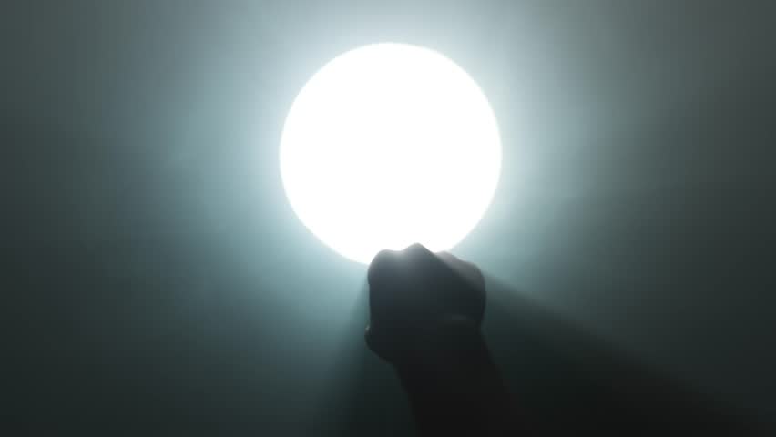 Hand Reaching Toward Light at the End of a Dark Tunnel