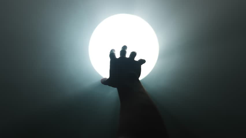 Hand Reaching Toward Light at the End of a Dark Tunnel