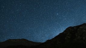 Beautiful night sky time lapse with Milky Way galaxy over mountain. Night tight landscape starry sky. - Powered by Shutterstock - Get 15% off with code: PIKWIZARD15